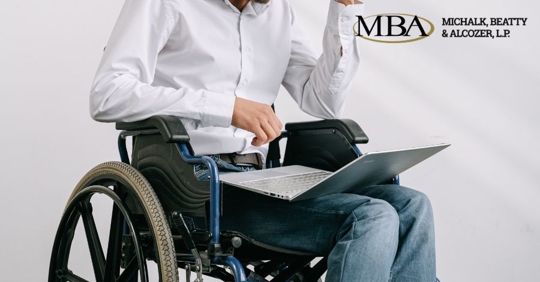person on wheelchair using a laptop